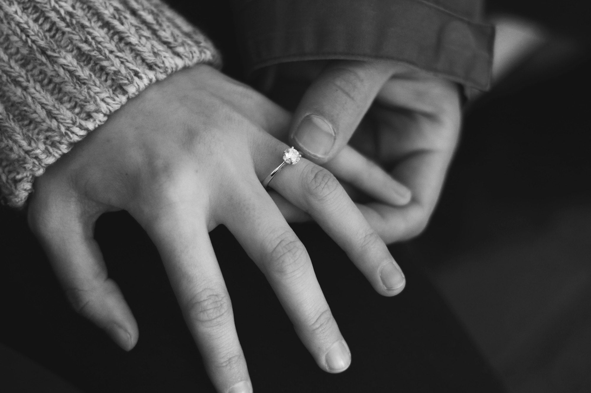 Silver diamond solitaire engagement ring on red velvet